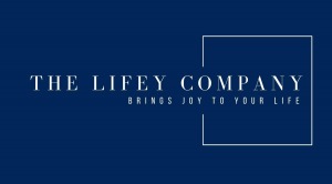 Female sitting on a couch with her dog holding the Lifey Nutrient Test Kit